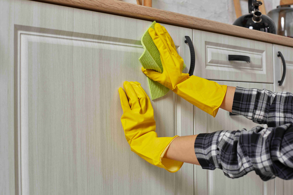 hands-gloves-with-green-rag-is-cleaning-kitchen-cabinets-housework-housekeeping-concept-close-up_11zon.jpg