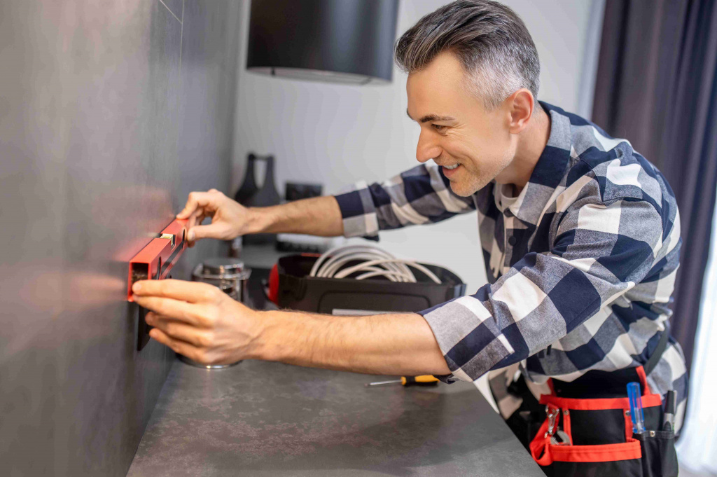 man-touching-measuring-device-wall-near-power-socket_11zon.jpg